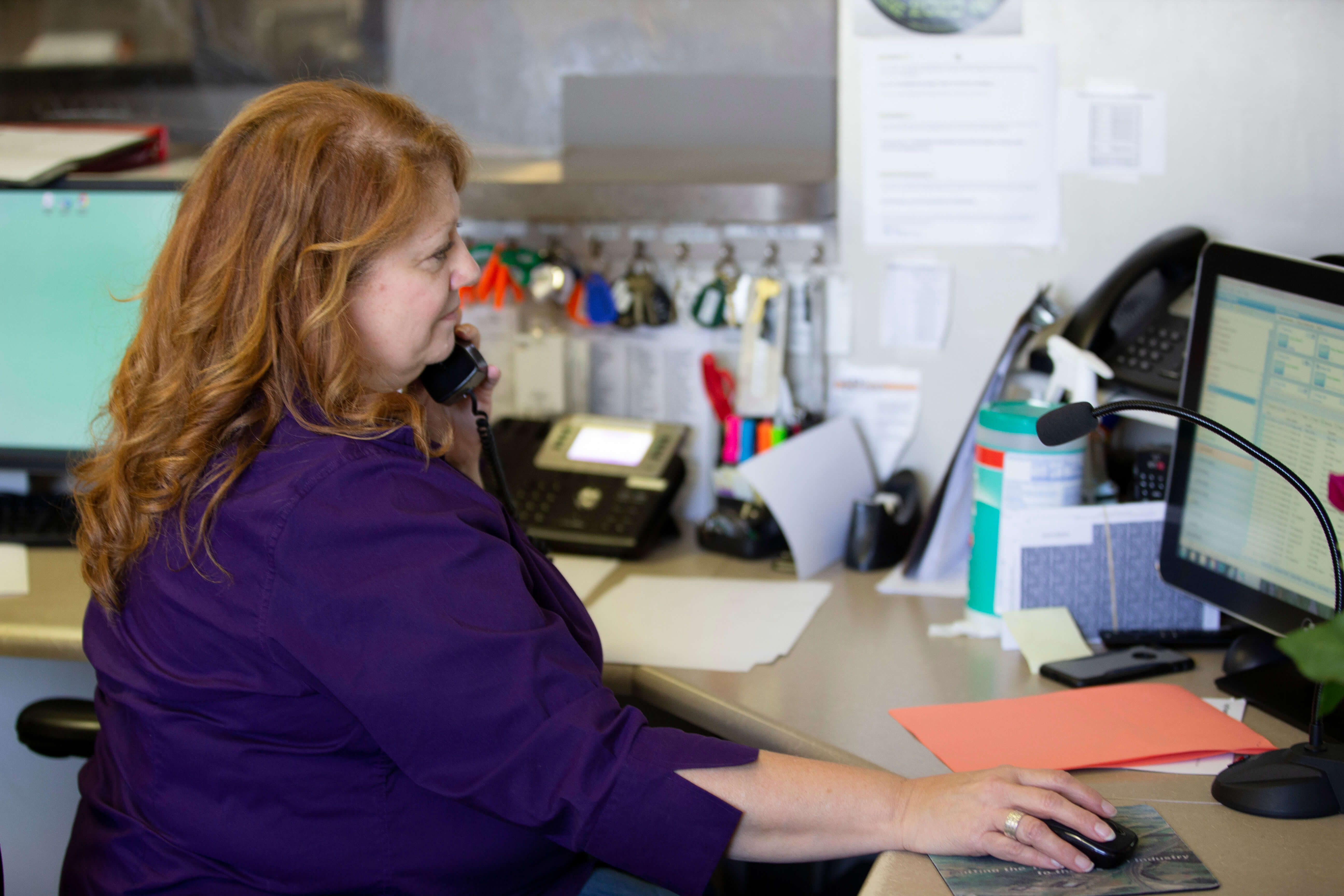 TRC Employee On Phone In Office