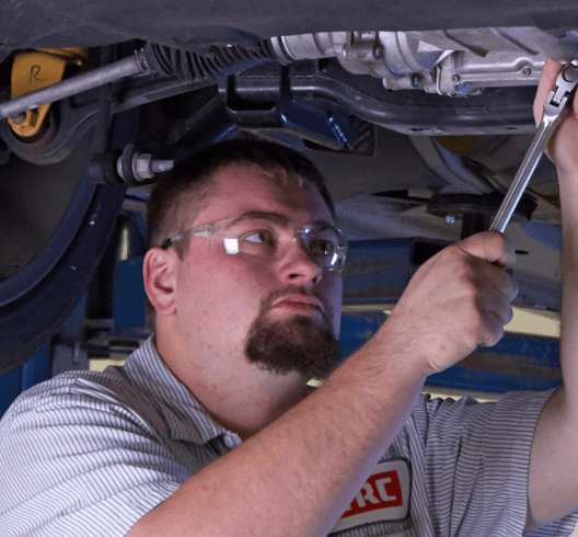 TRC Employee Working On Bottom Of Car